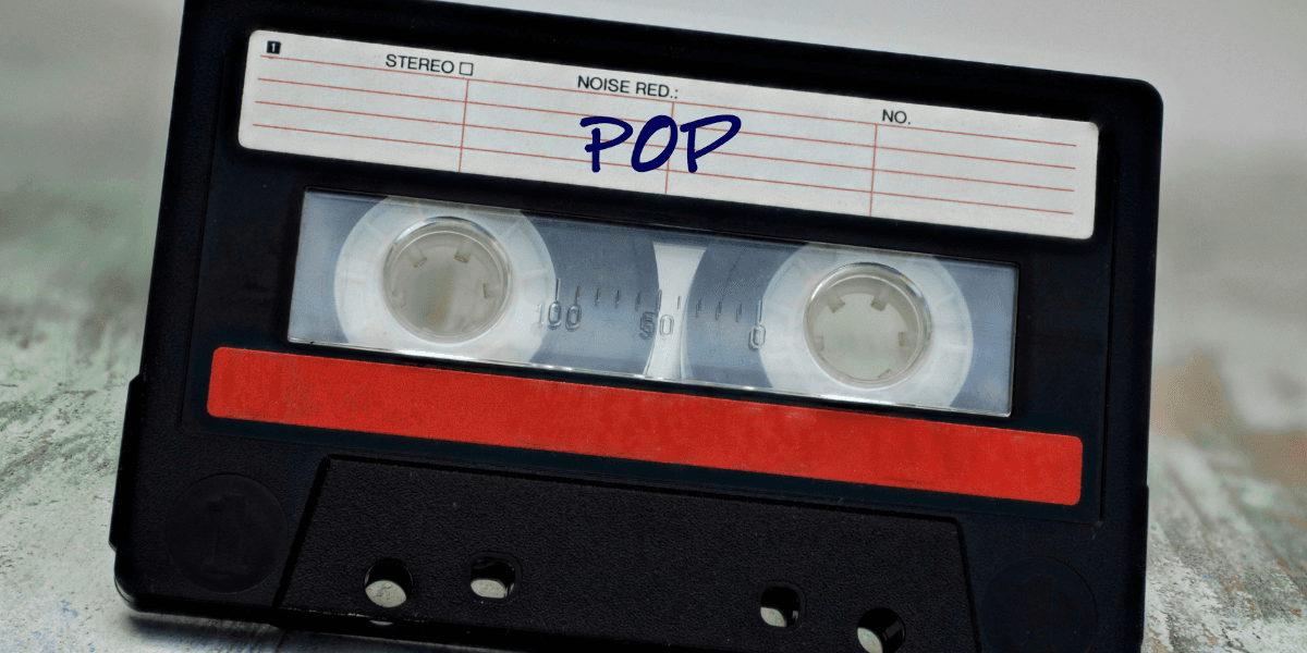 Black cassette tape with a red label marked "POP" on a textured background