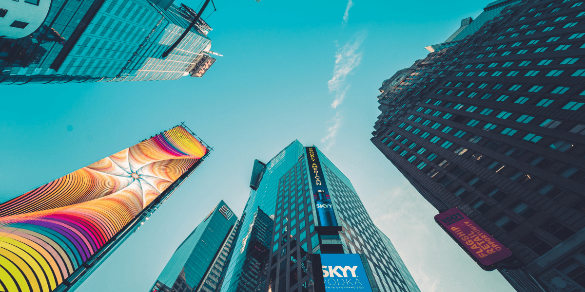 Skyscrapers and billboards in an urban area against a clear blue sky
