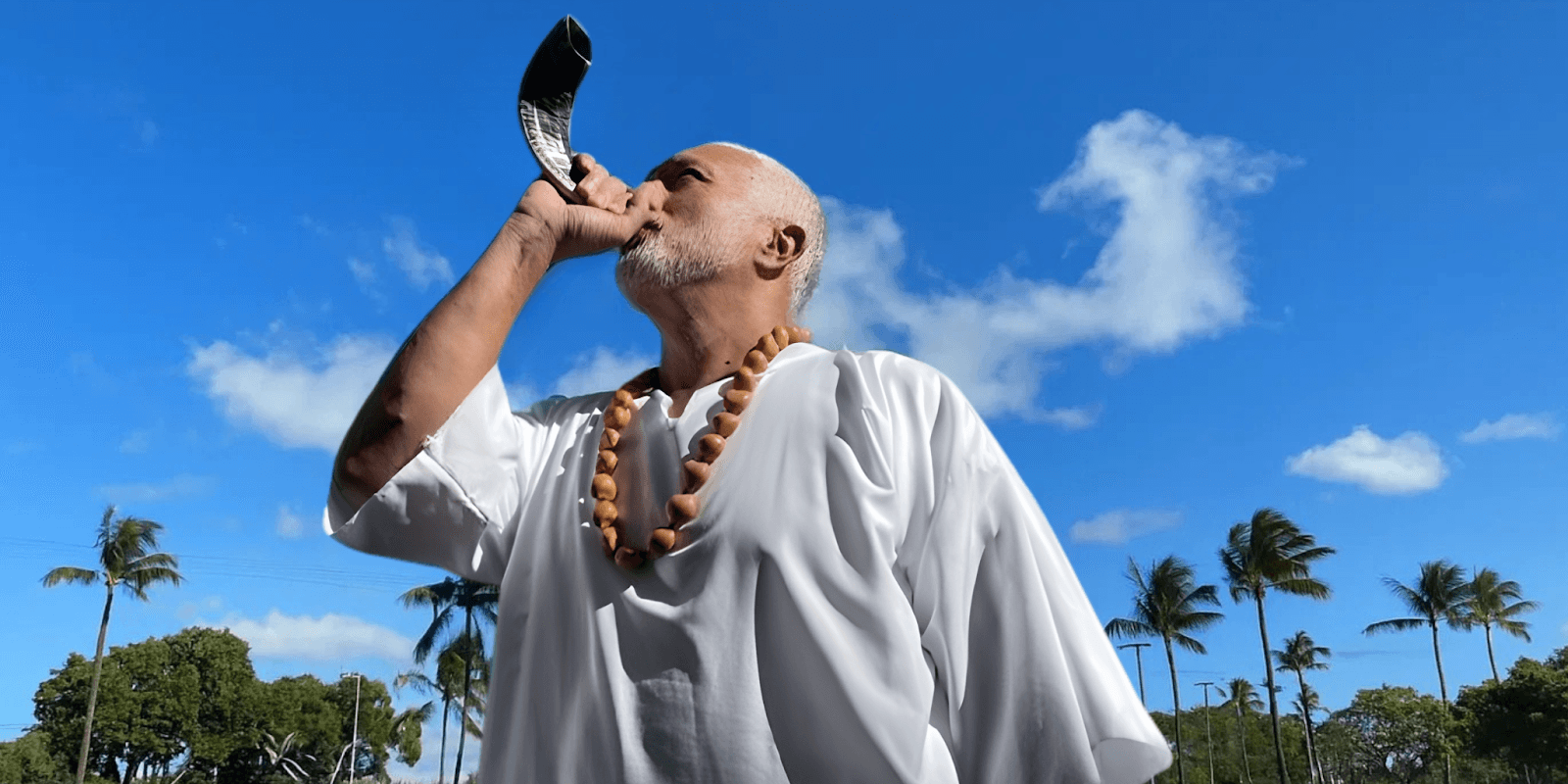 Apostle Constantine I. Nightingdale calling for transformation and spiritual awakening with a shofar.