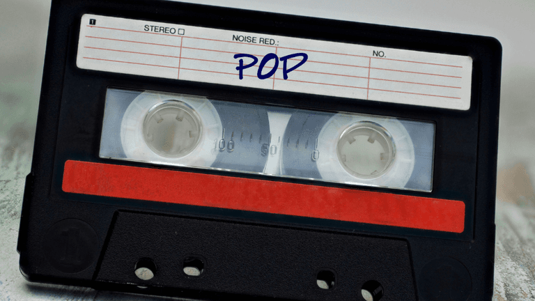 Black cassette tape with a red label marked "POP" on a textured background