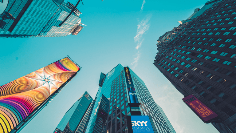 Skyscrapers and billboards in an urban area against a clear blue sky
