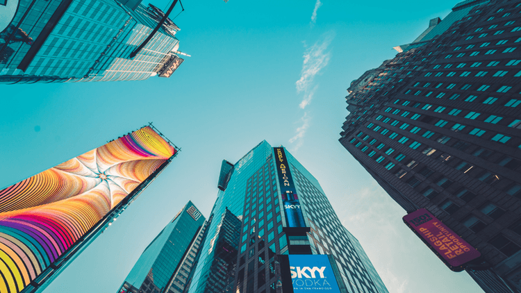 Skyscrapers and billboards in an urban area against a clear blue sky