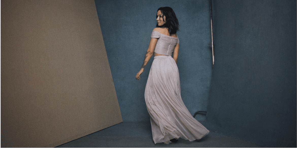 Melissa Nathalia in a pink gown, exuding elegance and strength, embracing cultural reclamation through creative expression.